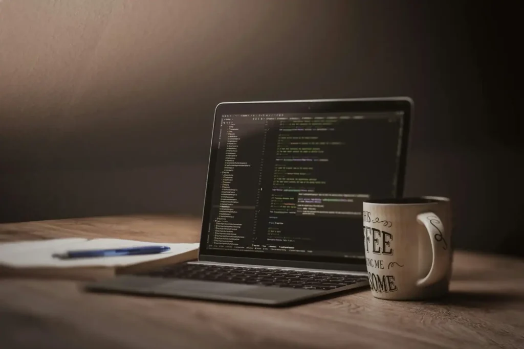 coding on laptop with coffee